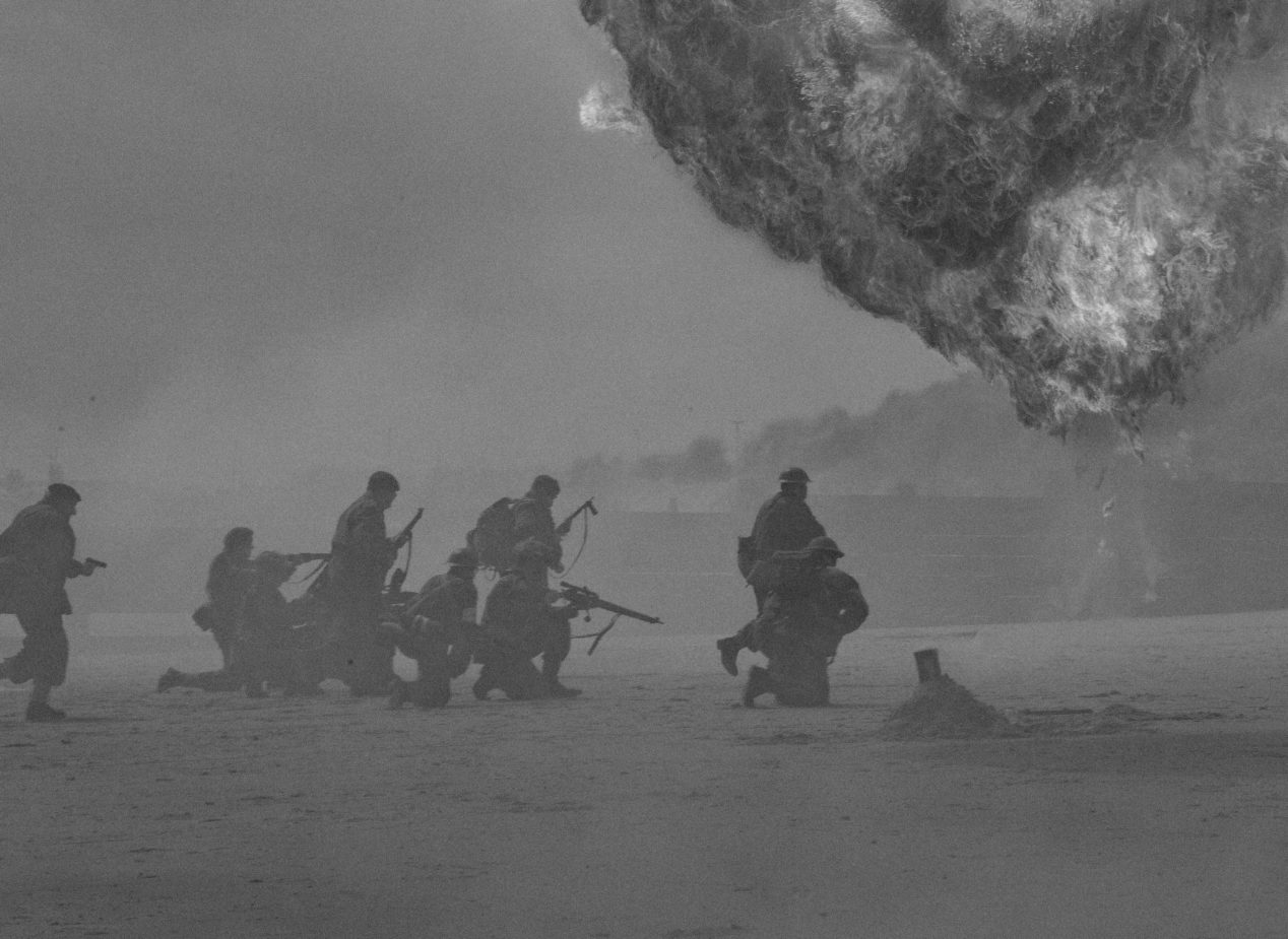 Black and white photo of soldiers on a beach from a World War Two reenactment.