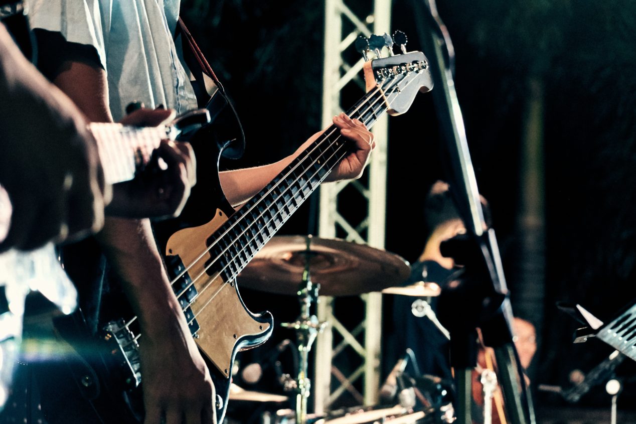 Photo of a Fender P-Bass being played on stage.