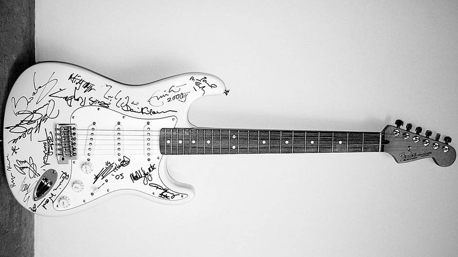 Photo of the "Reach Out to Asia" stratocaster in black and white.
