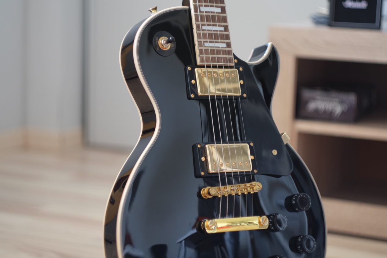 Photo of a black Les Paul in a room.